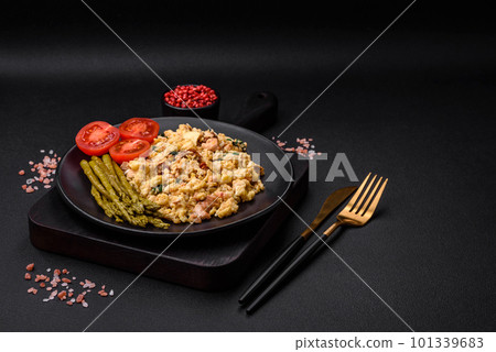 Delicious scramble with salmon, sun-dried tomatoes, spinach, spices and herbs Delicious scramble with salmon, sun-dried tomatoes, spinach, spices and herbs 101339683