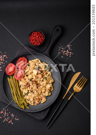 Delicious scramble with salmon, sun-dried tomatoes, spinach, spices and herbs Delicious scramble with salmon, sun-dried tomatoes, spinach, spices and herbs 101339685