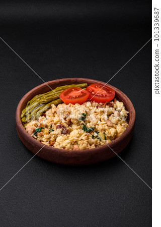 Delicious scramble with salmon, sun-dried tomatoes, spinach, spices and herbs Delicious scramble with salmon, sun-dried tomatoes, spinach, spices and herbs 101339687