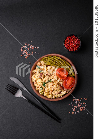 Delicious scramble with salmon, sun-dried tomatoes, spinach, spices and herbs Delicious scramble with salmon, sun-dried tomatoes, spinach, spices and herbs 101339696