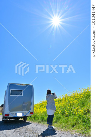 A spring drive in a camper A woman taking a picture with a smartphone 101341447