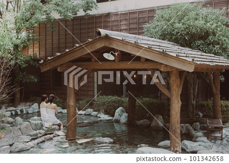 A young woman taking a leisurely open-air bath A young woman taking a leisurely open-air bath 101342658