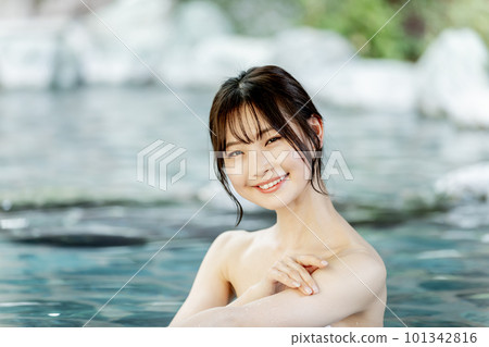 A young woman taking a leisurely open-air bath 101342816