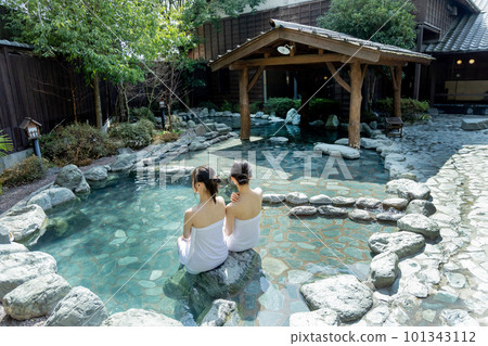 Two young women taking a leisurely open-air bath Two young women taking a leisurely open-air bath 101343112