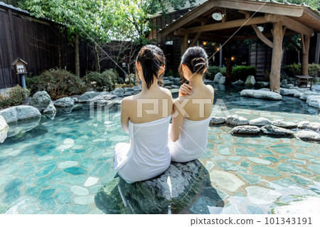 Two young women taking a leisurely open-air bath Two young women taking a leisurely open-air bath 101343191