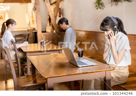 A business woman talking quietly in a cafe / coffee shop 101344246