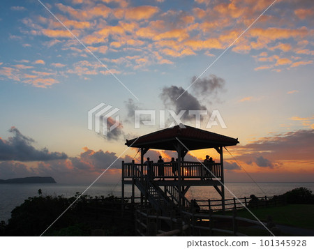 People looking at the sunset over the sea from the Unarizaki Park observation deck on Iriomote Island People looking at the sunset over the sea from the Unarizaki Park observation deck on Iriomote Island 101345928