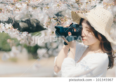 Woman with cherry and camera 101345967