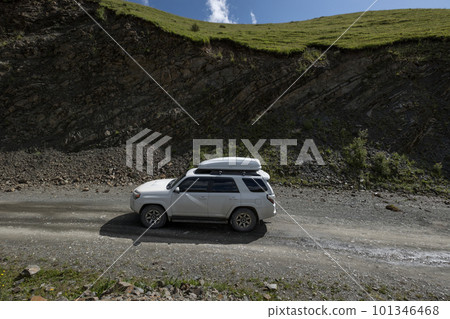 Driving off road car on high altitude mountain top 101346468