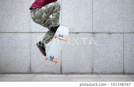 Asian woman skateboarder skateboarding in modern city Asian woman skateboarder skateboarding in modern city 101346587