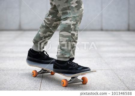 Asian woman skateboarder skateboarding in modern city Asian woman skateboarder skateboarding in modern city 101346588