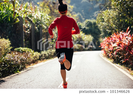Healthy lifestyle oman runner running on winter park trail Healthy lifestyle oman runner running on winter park trail 101346626