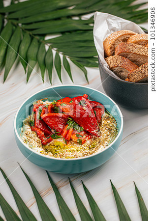 Portion of hummus bowl with baked pepper Portion of hummus bowl with baked pepper 101346908