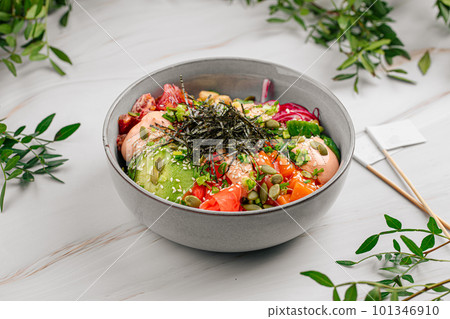 Portion of salmon poke bowl with vegetables 101346910