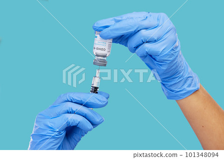 Mockup, closeup and hands with needle, vial and vaccination for diagnosis against a blue studio background. Zoom, hands and gloves, with medicine, cure and vaccination for medical diagnosis or result 101348094