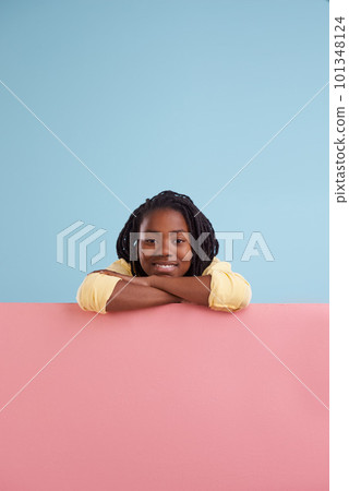 Take my advice. Studio portrait of a happy young boy leaning on a blank signboard. Take my advice. Studio portrait of a happy young boy leaning on a blank signboard. 101348124
