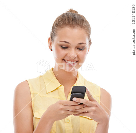 Staying in touch with all her friends. A cute young teen sending text messages while isolated on white. 101348126
