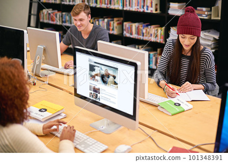 Fill your mind with knowledge. students working on computers in a university library. 101348391