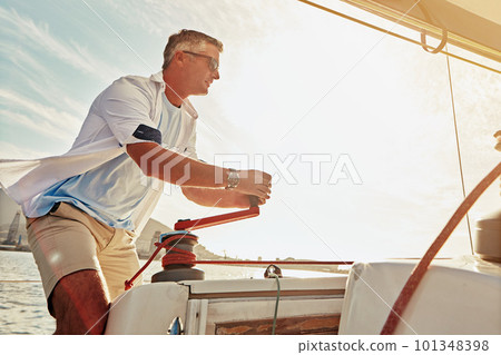 Retirement, luxury yacht and investment for mature man and sailing winch in mast control, wind management or speed. Person, tourism boat and rope handle in wealth holiday and water location vacation 101348398