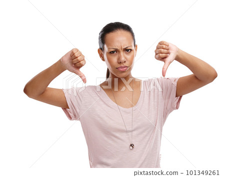 Woman, upset and thumbs down with unhappy expression for disagreement, wrong or fail against a white background. Portrait of isolated female model showing down thumbs in disapproval, no or failure 101349261