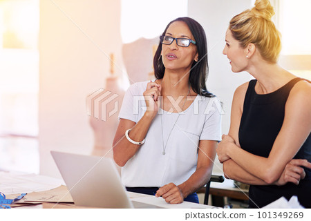 Theyve got some big ideas. two coworkers using a laptop together in a boutique. 101349269