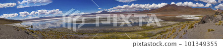 Scene of salt lagoon reflecting mountains and clouds as if in a mirror Scene of salt lagoon reflecting mountains and clouds as if in a mirror 101349355