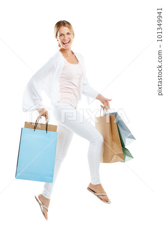 Happy woman jump with bag from shopping, fashion and retail, customer in air isolated on white background. Smile in portrait, luxury designer brand and clothes, gift and discount sale with freedom 101349941