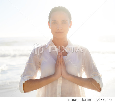 Nature helps me find peace. A beautiful young woman meditating outside. 101350078