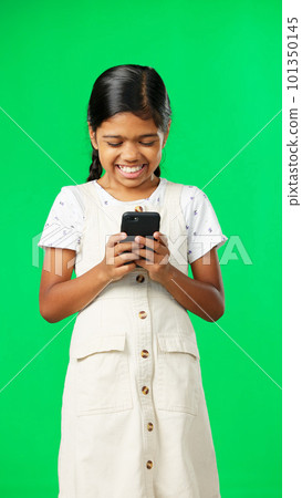 Happy, green screen and girl with smartphone, typing and laughing against a studio background. Mobile app, young person and female child with cellphone, connection and communication on social media Happy, green screen and girl with smartphone, typing and laughing against a studio background. Mobile app, young person and female child with cellphone, connection and communication on social media 101350145