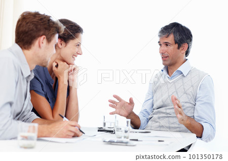 Working out business policies. three positive-looking businesspeople talking together in a meeting. Working out business policies. three positive-looking businesspeople talking together in a meeting. 101350178