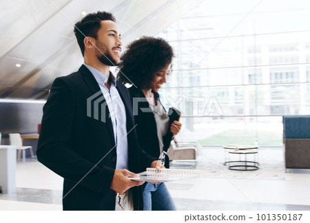 Let your drive keep moving you forward. Shot of a young businessman and businesswoman having a conversation while walking through a modern office. 101350187