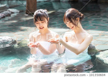 Two young women taking a leisurely open-air bath Two young women taking a leisurely open-air bath 101350604