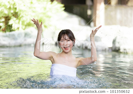 A young woman taking a leisurely open-air bath A young woman taking a leisurely open-air bath 101350632
