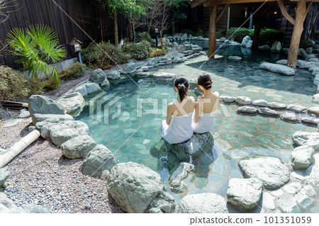 Two young women taking a leisurely open-air bath Two young women taking a leisurely open-air bath 101351059