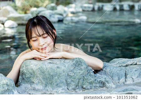 A young woman taking a leisurely open-air bath A young woman taking a leisurely open-air bath 101351062