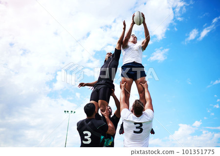 Great team mates help you reach your goals. a group of young men playing a game of rugby. Great team mates help you reach your goals. a group of young men playing a game of rugby. 101351775
