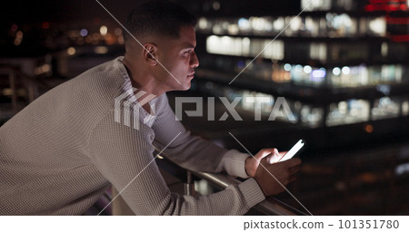 Business man, phone and night data while online on an urban building rooftop typing email, search or communication for networking on trading app. Entrepreneur on terrace in dark with 5g network 101351780