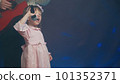 Little girl on stage in vintage dress, she sings into microphone and dances, her father plays acoustic guitar. Color music is shining and smoke is billowing. Father and Child Day, performance on stage 101352371