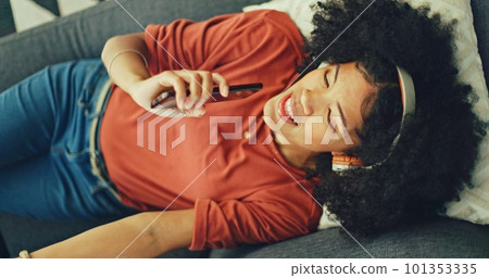 Phone, music and singing with a black woman lying on a sofa in her home on the weekend from above. Mobile, karaoke and dance with a young female having fun alone in the living room of her house Phone, music and singing with a black woman lying on a sofa in her home on the weekend from above. Mobile, karaoke and dance with a young female having fun alone in the living room of her house 101353335