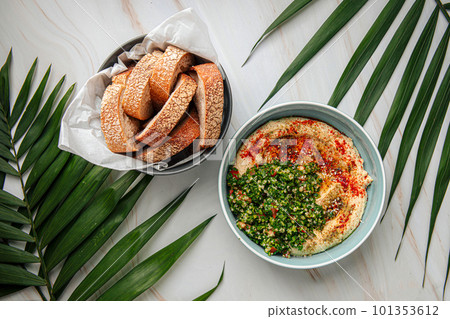 Hummus bowl with tabbouleh salad and bread Hummus bowl with tabbouleh salad and bread 101353612