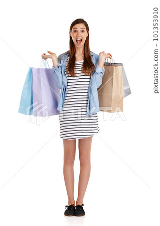 Bags full of awesome. Studio shot of a beautiful young woman holding shopping bags against a white background. Bags full of awesome. Studio shot of a beautiful young woman holding shopping bags against a white background. 101353910