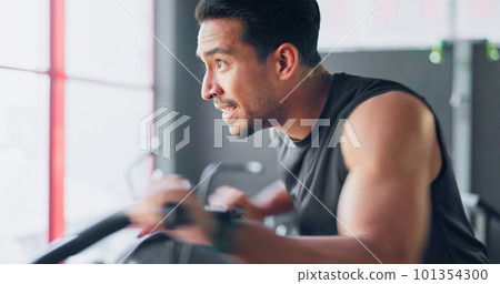 Strong man, gym air bike and cardio training for exercise, workout and strong body, muscle and power in fitness club. Happy, healthy and young bodybuilder cycling fast on stationary bicycle machine Strong man, gym air bike and cardio training for exercise, workout and strong body, muscle and power in fitness club. Happy, healthy and young bodybuilder cycling fast on stationary bicycle machine 101354300