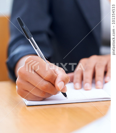 Putting pen to paper...Closeup image of a businesswoman writing in a notebook. 101354533