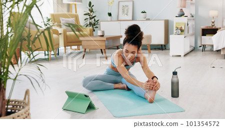 Fitness, yoga or meditation stretching woman for workout in the living room of her house. Girl with chakra focus, mindset or balance while training, exercise or health with zen pilates for wellness. 101354572