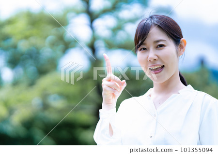 A smiling woman enjoying the fresh green A smiling woman enjoying the fresh green 101355094