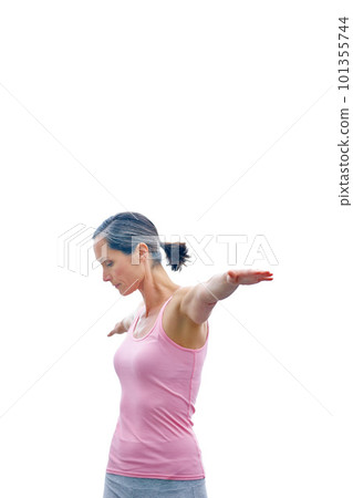 In complete control of her body. an attractive mature woman doing yoga outdoors. In complete control of her body. an attractive mature woman doing yoga outdoors. 101355744