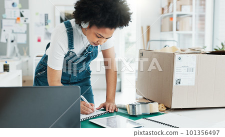 Delivery, ecommerce and shipping with woman writing logistics information from laptop for online shopping, product or checklist. Storage, stock and cargo with employee in retail warehouse factory 101356497
