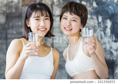 A woman holding a glass of water A woman holding a glass of water 101356855