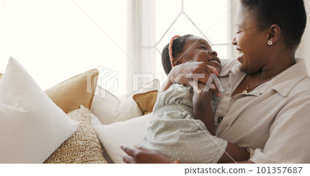 Happy family, mother and child play in a house with love, laughing and freedom on a sofa in a living room. Smile, girl and funny mama enjoy having fun, bonding and tickling quality time together Happy family, mother and child play in a house with love, laughing and freedom on a sofa in a living room. Smile, girl and funny mama enjoy having fun, bonding and tickling quality time together 101357687