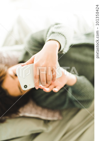 A woman operating a smartphone 101358424